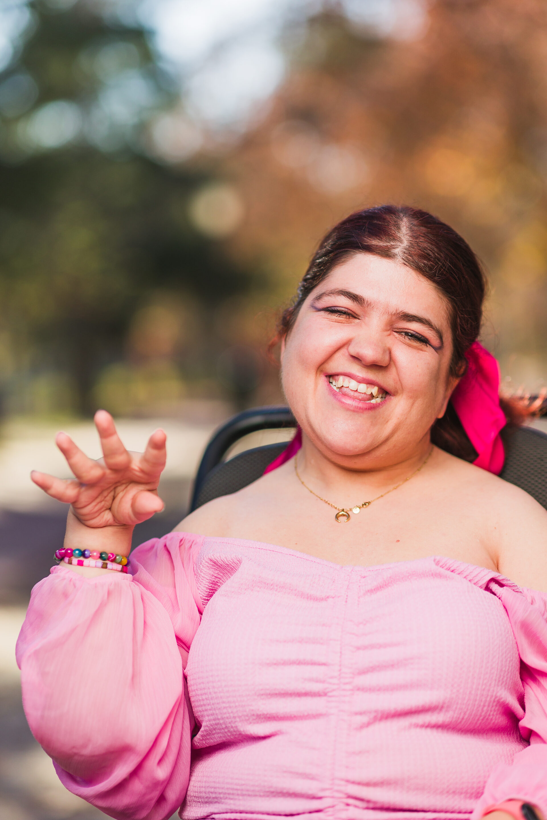 Young empowered woman looking at camera on an electric wheelchair.